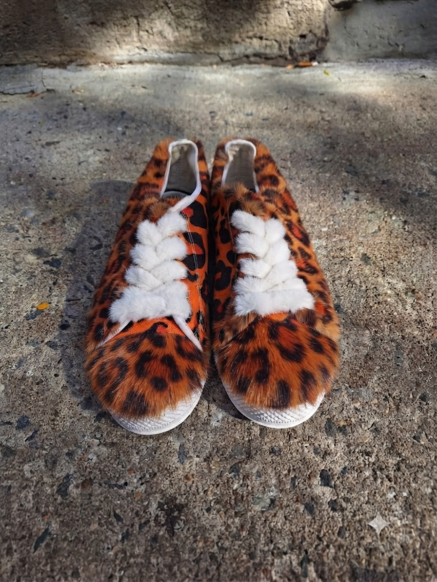 The Khool Closet "The Orange Cheetah" mink low top sneakers for women.